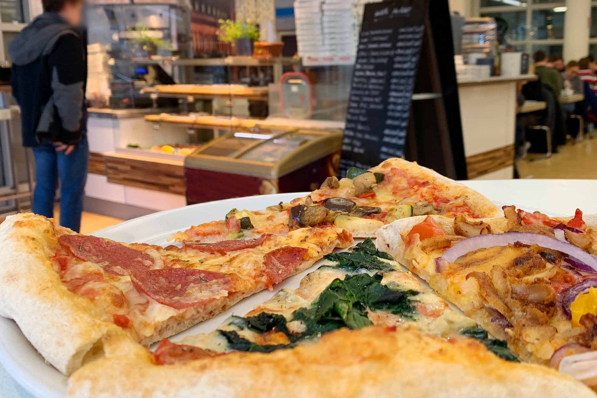 Auswahl an Pizzen mit Tresen der PizzaBar Harburg