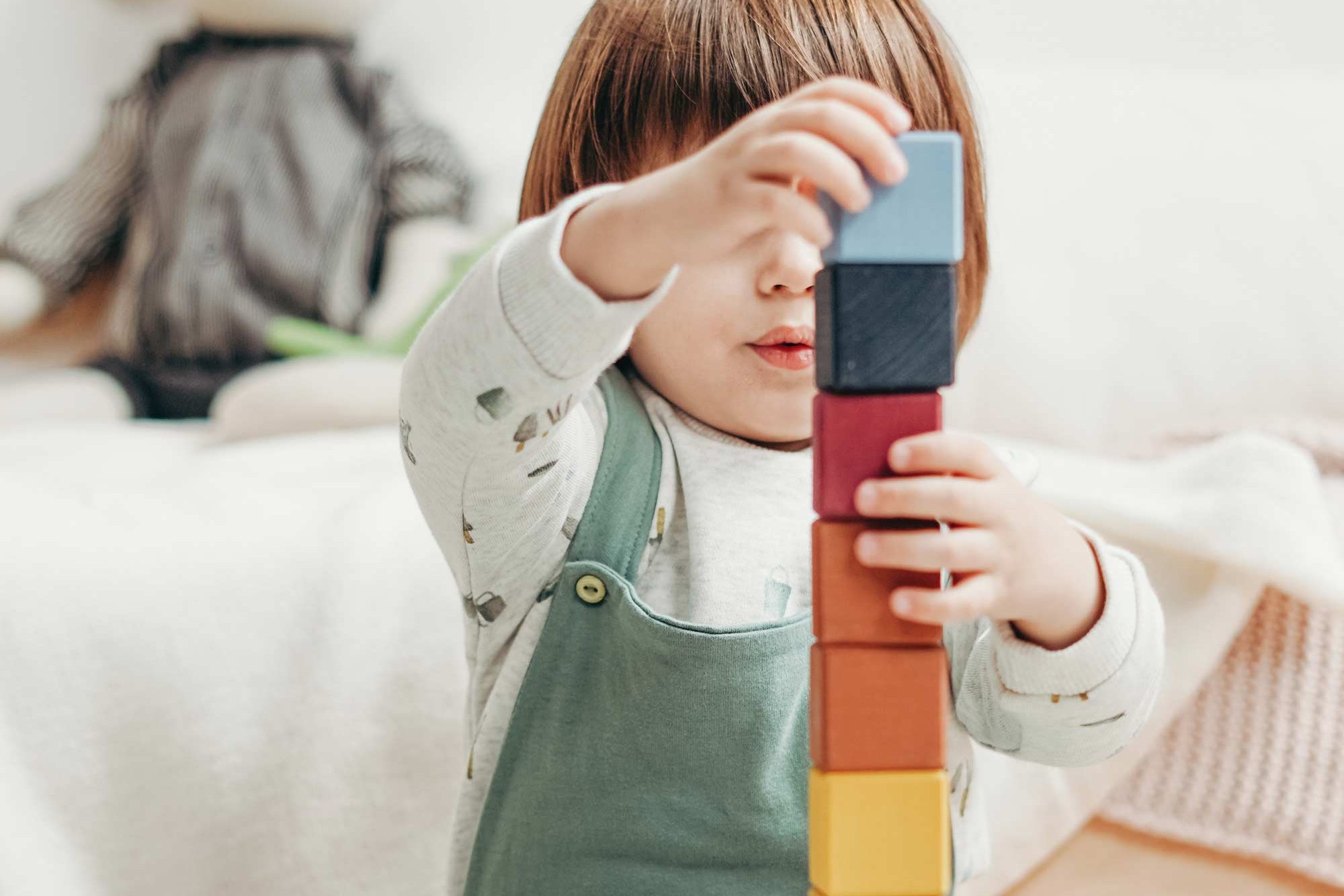 A small child plays with building blocks.